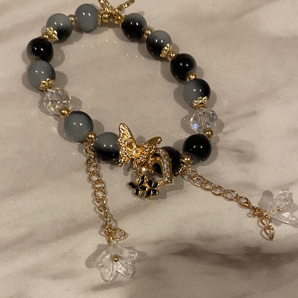 Elegant Gold and Black Beaded Bracelet with Butterfly Charm